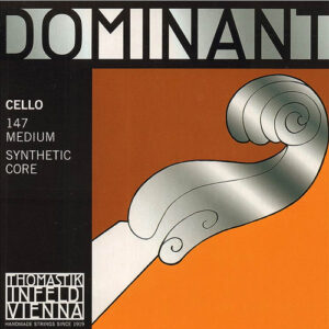 Product packaging for Dominant cello strings, featuring bold text and an illustration of a cello scroll on an orange background. The text specifies "Cello 147 Medium Synthetic Core" and "Thomastik-Infeld Vienna.