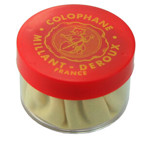 A round container of Millant-Deroux colophane (rosin) with a red lid featuring gold text and an illustration; the container is partially transparent, showing the light-colored rosin inside.